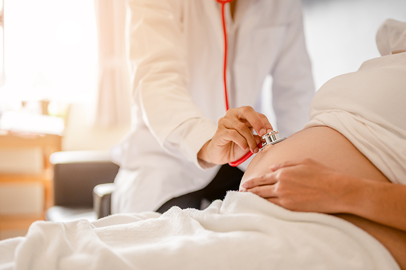 A doctor examining a pregnant woman.