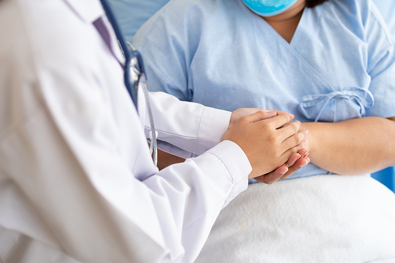 Female patient in consultation with an abortion doctor in a clinic setting.