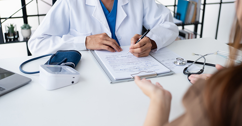 Woman speaking with an abortion doctor during a medical consultation.