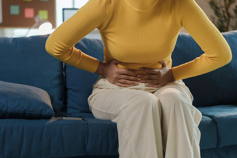 A woman suffering from significant abdominal pain.